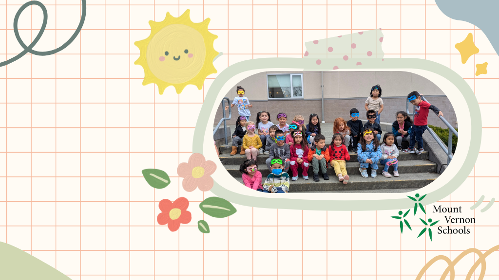 Students sitting on steps of school