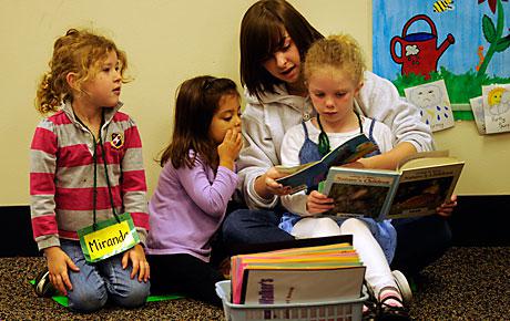 Image of volunteer working with students